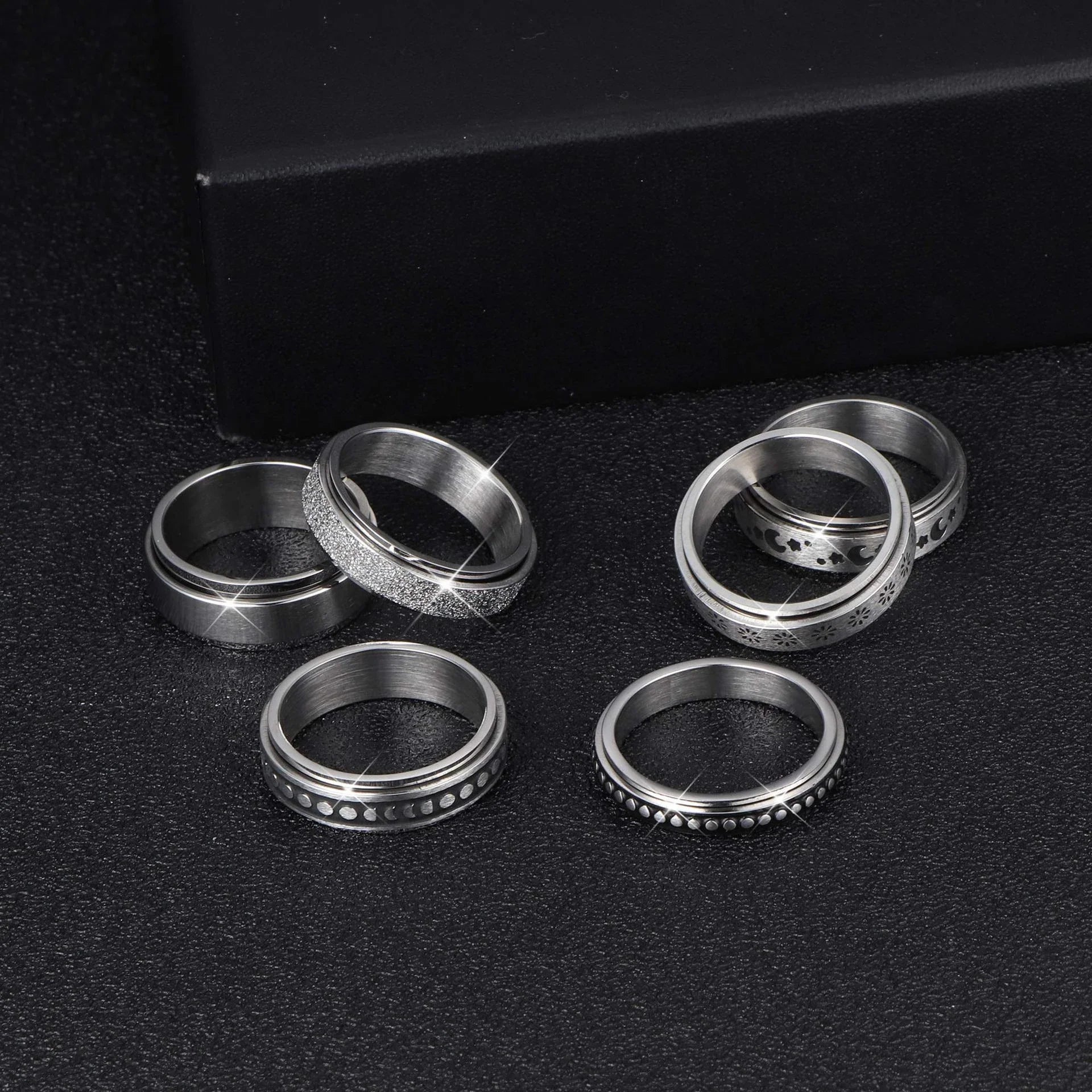 Rotatable stainless steel spinner ring with moon and star designs for anxiety relief and style