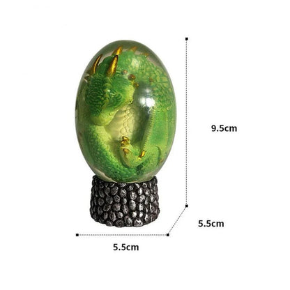 A lifelike resin dragon egg ornament with a crystal-clear, transparent design, sitting on a glowing lava-style base.