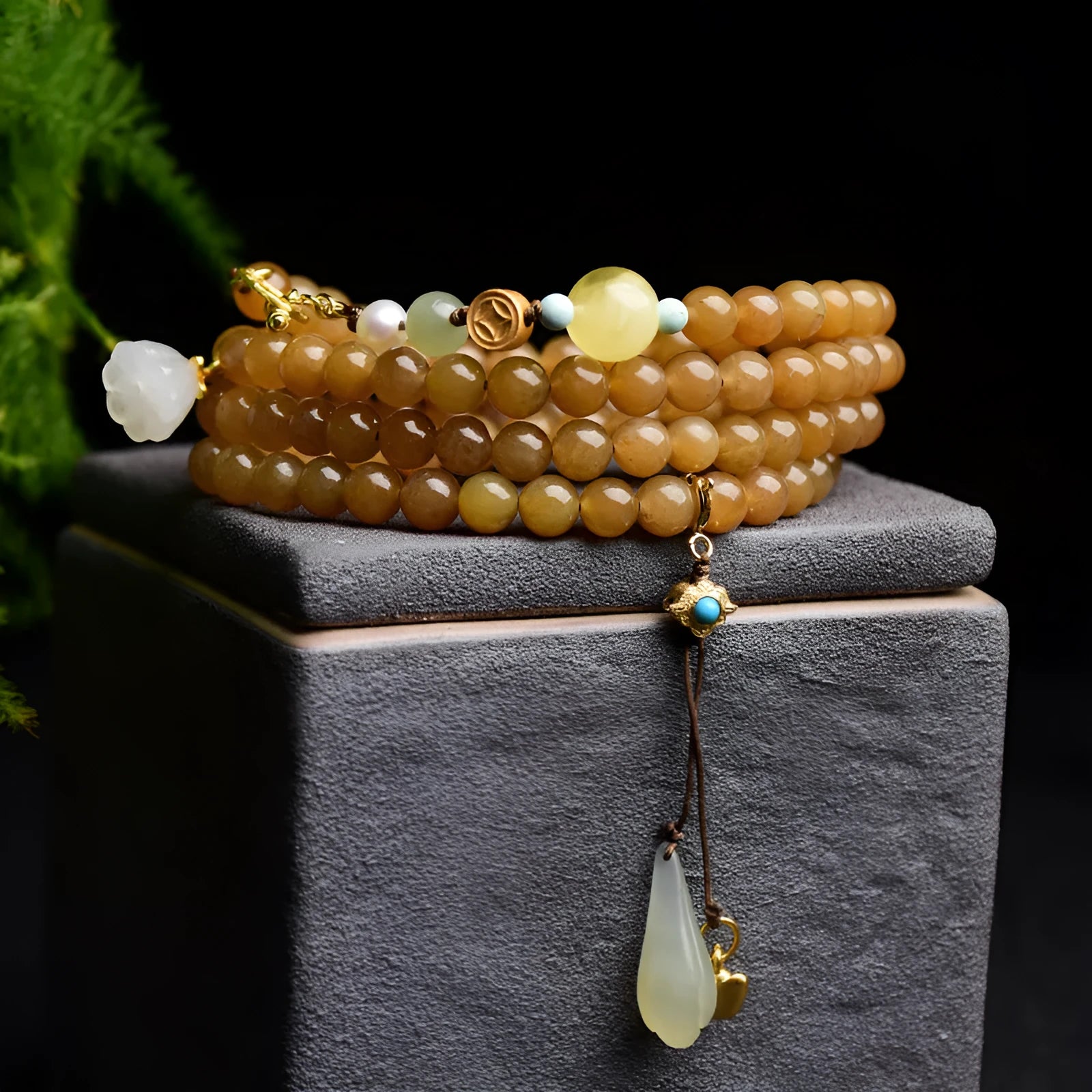 Women's green pine bead bracelet with jade leaves and sequin details on wrist