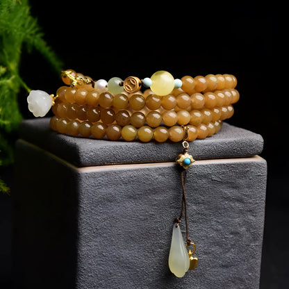 Women's green pine bead bracelet with jade leaves and sequin details on wrist