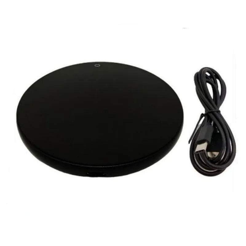 Black USB heating coaster with a mug on its tempered glass surface, showing a red LED indicator light.