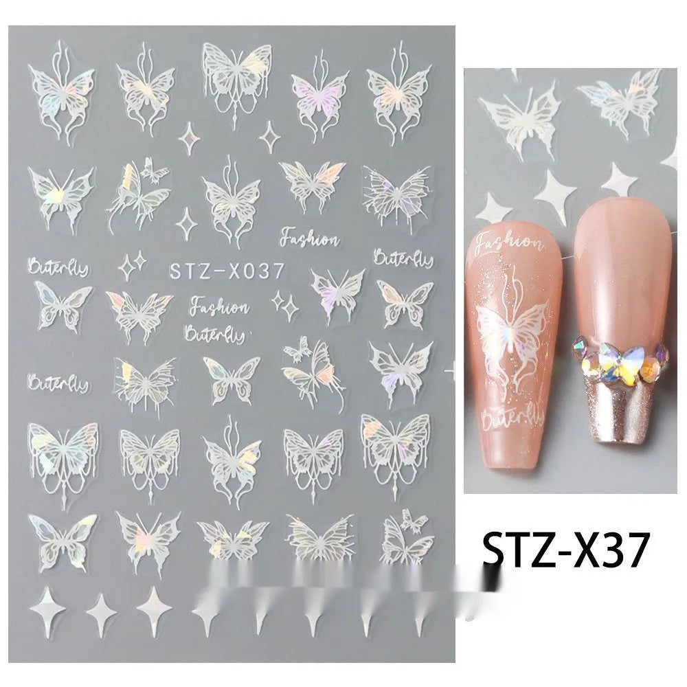 Assortment of black and silver nail sticker designs including cartoon and French tip patterns on a plastic sheet.