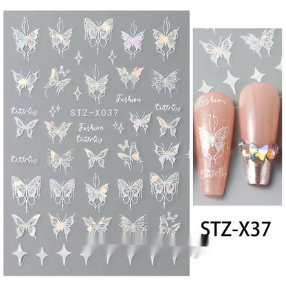 Assortment of black and silver nail sticker designs including cartoon and French tip patterns on a plastic sheet.