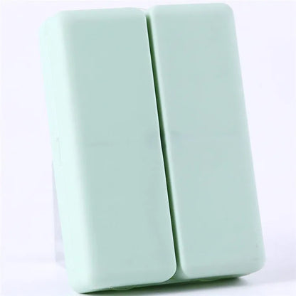 Blue foldable pill box with seven compartments and magnetic closure showing open and closed positions