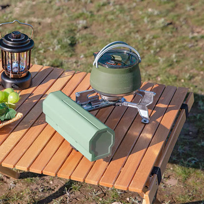 Green folding camping gas stove with serrated pot bracket, showing 25cm size next to butane canister