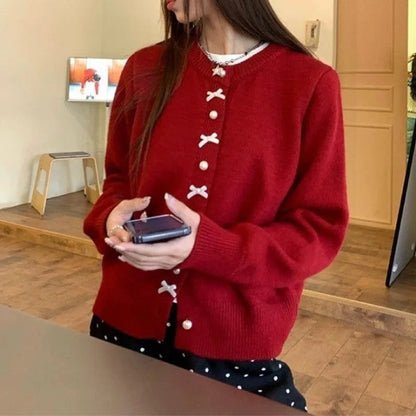 Women's acrylic cardigan sweater with pearl button bow detail in light yellow colour