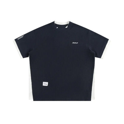 Loose fit waffle fabric T-shirt with retro alphabet embroidery on the chest, shown in navy blue.