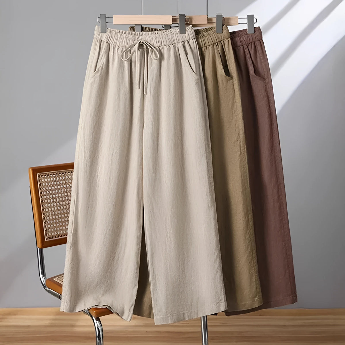 Women's apricot straight-leg casual trousers with elastic waist and drawstring lace-up detail.
