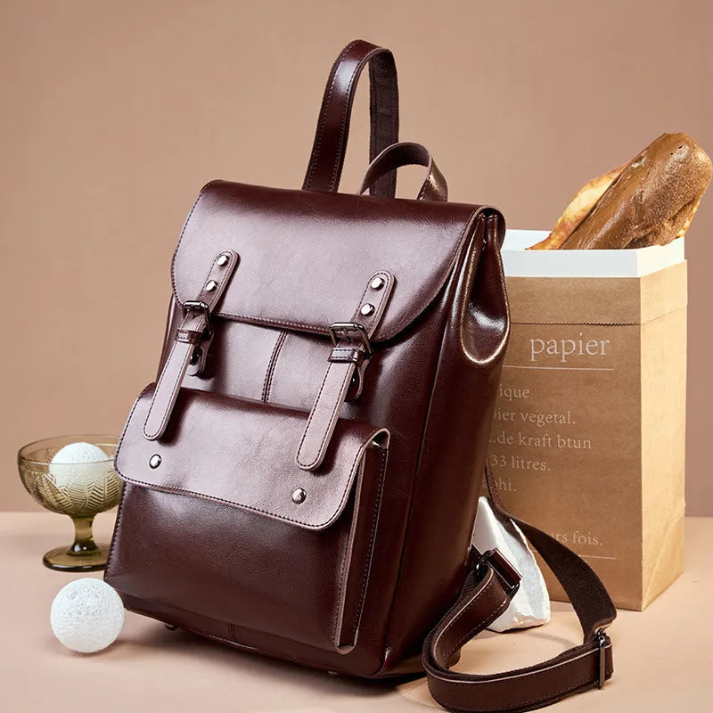 Leather backpack women's computer backpack crafted from genuine two-layer cowhide with a hard-wearing texture available in black brown and coffee colour options featuring a cloth lining for organised storage