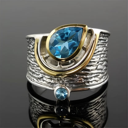 Creative Chinese style women's ring with an inlaid blue zircon stone in a drop shape on an alloy band.