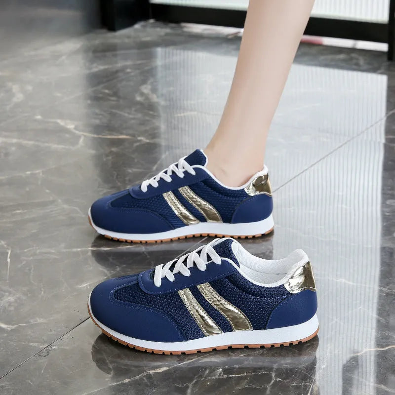 Blue women's casual sports shoes with cross shoulder straps and a round toe, featuring a flat heel and lace-up front.