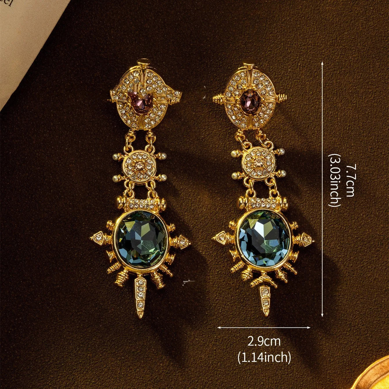 A pair of gold-coloured geometric stud earrings with round details and a retro style.
