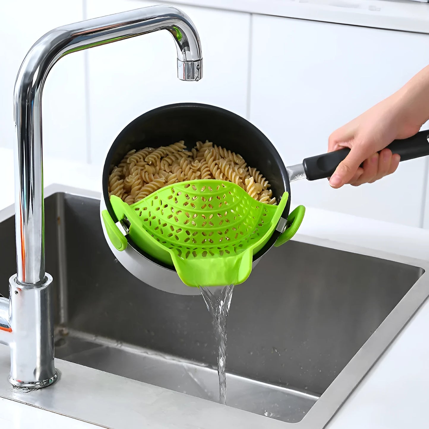 Silicone and stainless steel pot side drain stopper kitchen gadget in assorted colours.