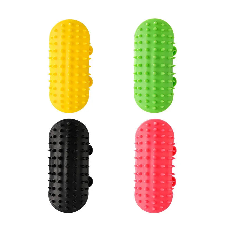 Silicone cat grooming comb with adjustable strap mounted on a table leg, shown in green.