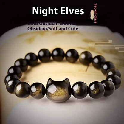 Obsidian cat head bracelet with round stone beads and a gold-toned cat charm on a wrist.