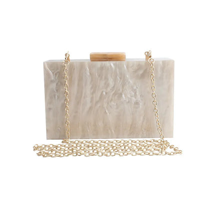 Small square acrylic clutch bag with long chain, marble pattern, and internal phone pocket
