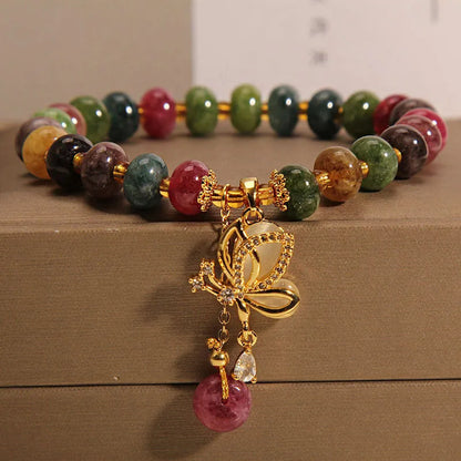 Close-up of a women's colourful butterfly bracelet with alloy construction, colourful beads, and tourmaline details.