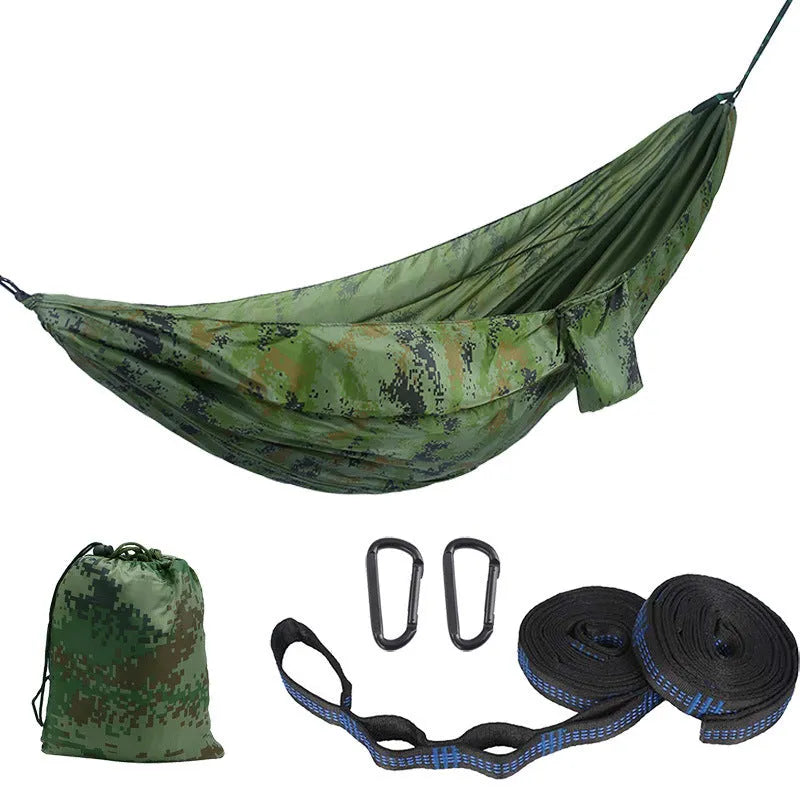 Parachute cloth double camping hammock in chosen colour, with black buckles and round ropes on a tree.