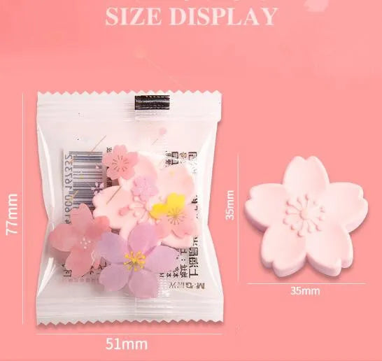 Assorted colourful cherry blossom shaped student erasers on a white background.