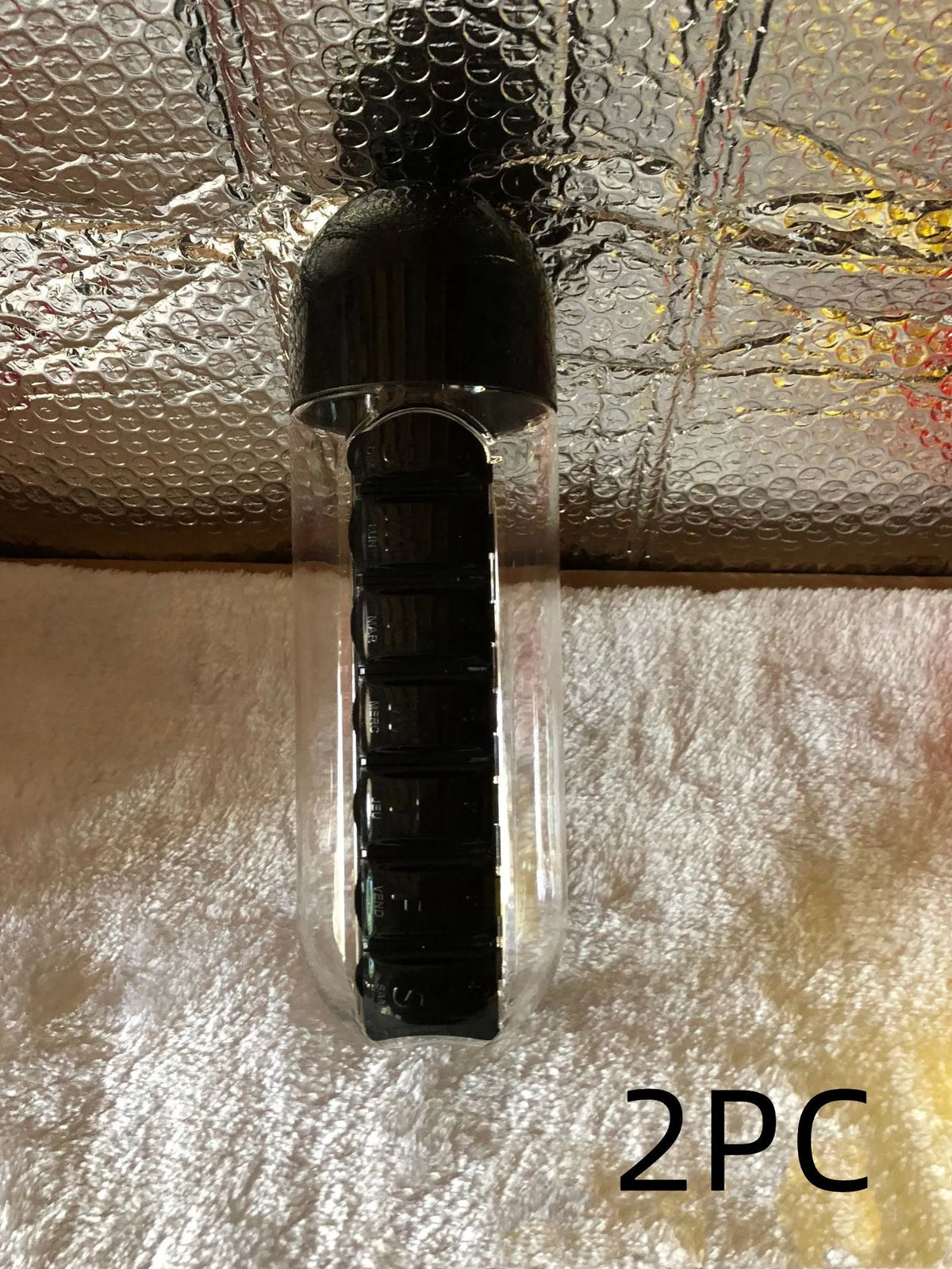 Water bottle with seven pill compartments attached, showing 600ml capacity and BPA-free construction