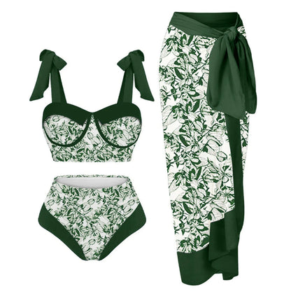 Women's pink and floral print split swimsuit three-piece set with skirt, bra, and panties.
