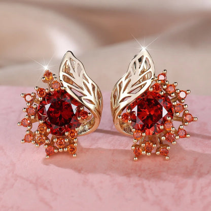 Rose gold plated women's stud earrings with a round flower shape, feather detail, and a central cubic zirconia stone.