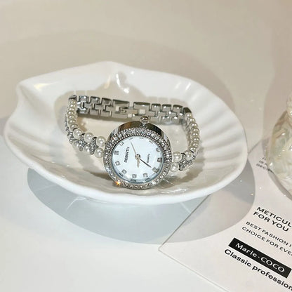 Women's vintage freshwater pearl bracelet watch with 25mm dial, steel strap, and double row pearl design in silver