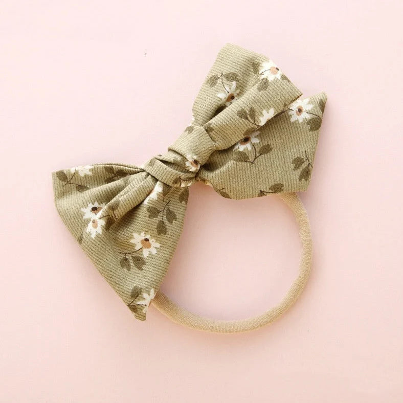Children's cloth hair band with knotted bow design in one of six colour options