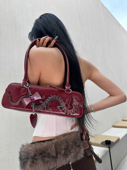 Red PU bowling bag with soft carry handle, sewing line detail, and single shoulder strap in new Chinese style.