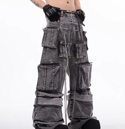 Grey distressed denim overalls jumpsuit with rope stitching on a hanger.