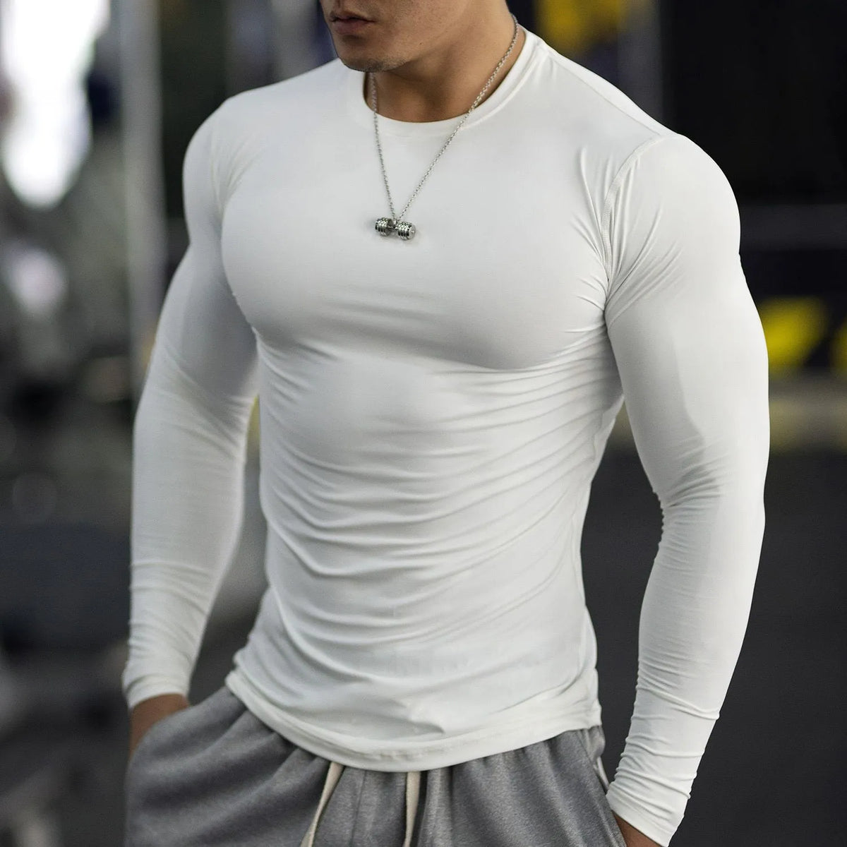 Men's black fitness tights with long sleeves and slim fit design for gym workouts and running
