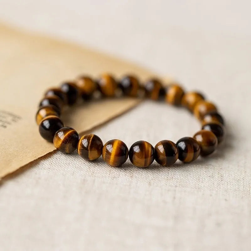 Tigereye dzi bead buddha bracelet with adjustable closure, shown in simple bracelet style.