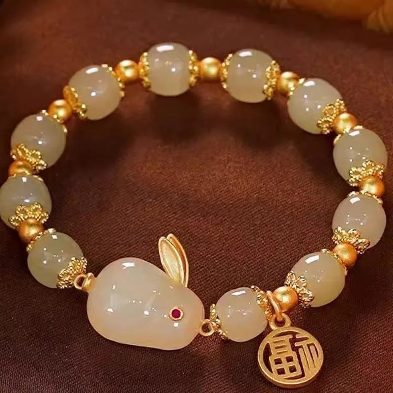 Green jade Lucky Hare charm bracelet with black cord and lily engraving.