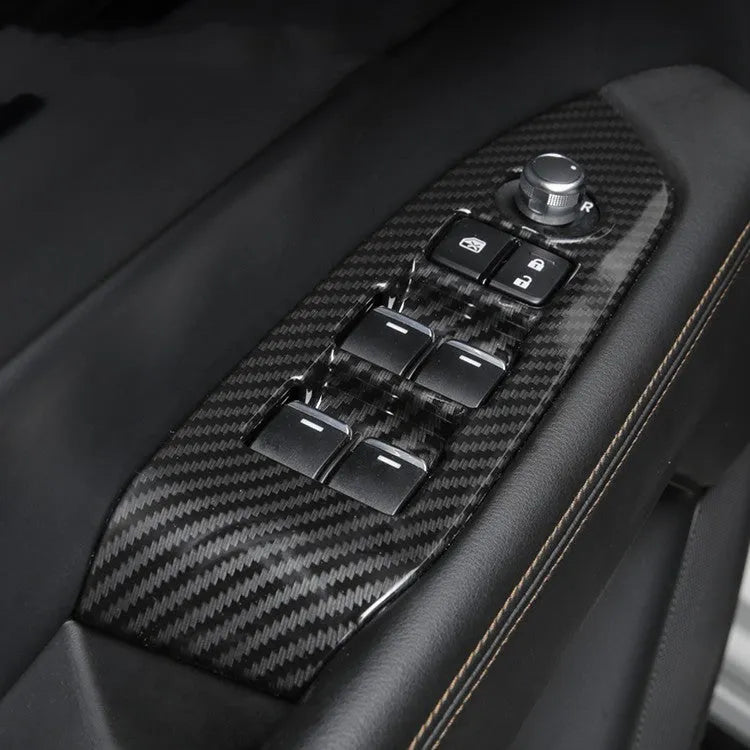 Carbon fibre patterned left and right steering wheel frame overlays for car interior upgrade.