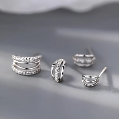 Pair of modern geometric stud earrings with a silver electroplated finish on a 925 silver post.
