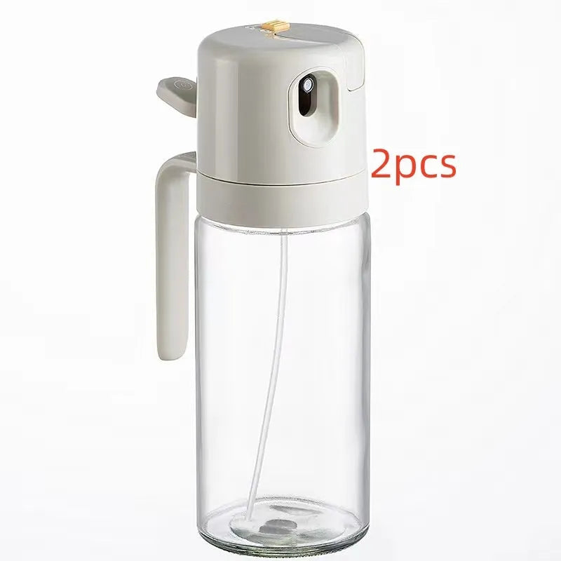 Warm grey glass oil sprayer bottle with a switchable nozzle for spray or pour modes.