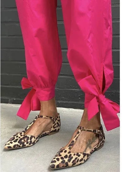 Women's leopard print pointed toe pumps with a low chunky heel and cross shoulder straps.