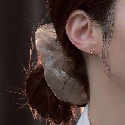 Pair of small spiral geometric ear studs with gold hollow thread finish in mixed material, shown in eight shape options.