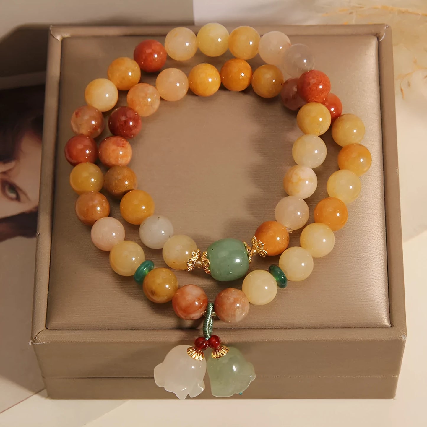 Natural green jade multi-strand bracelet with a silver-ton orchid charm for women.
