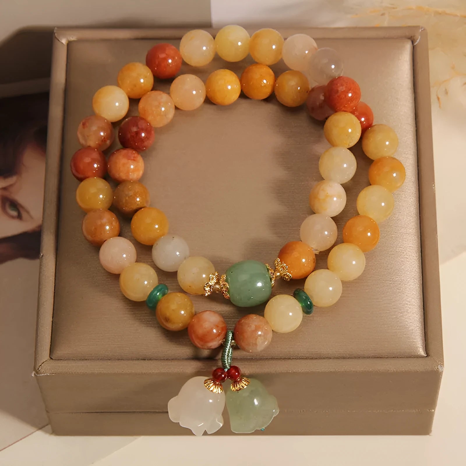 Natural green jade multi-strand bracelet with a silver-ton orchid charm for women.