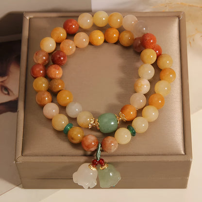 Natural green jade multi-strand bracelet with a silver-ton orchid charm for women.