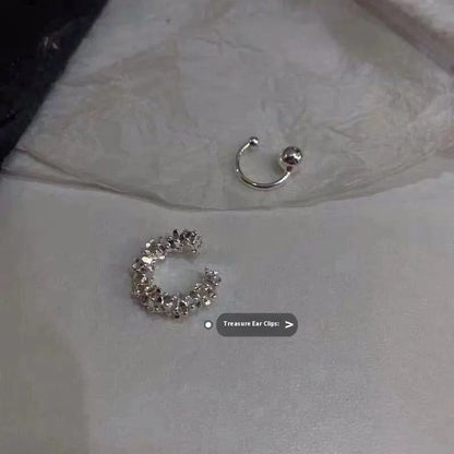 A pair of frosty-finish geometric clip-on earrings with an irregular abstract shape.