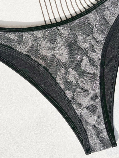 Black two-piece ladies bikini swimsuit with adjustable straps, shown on a model.