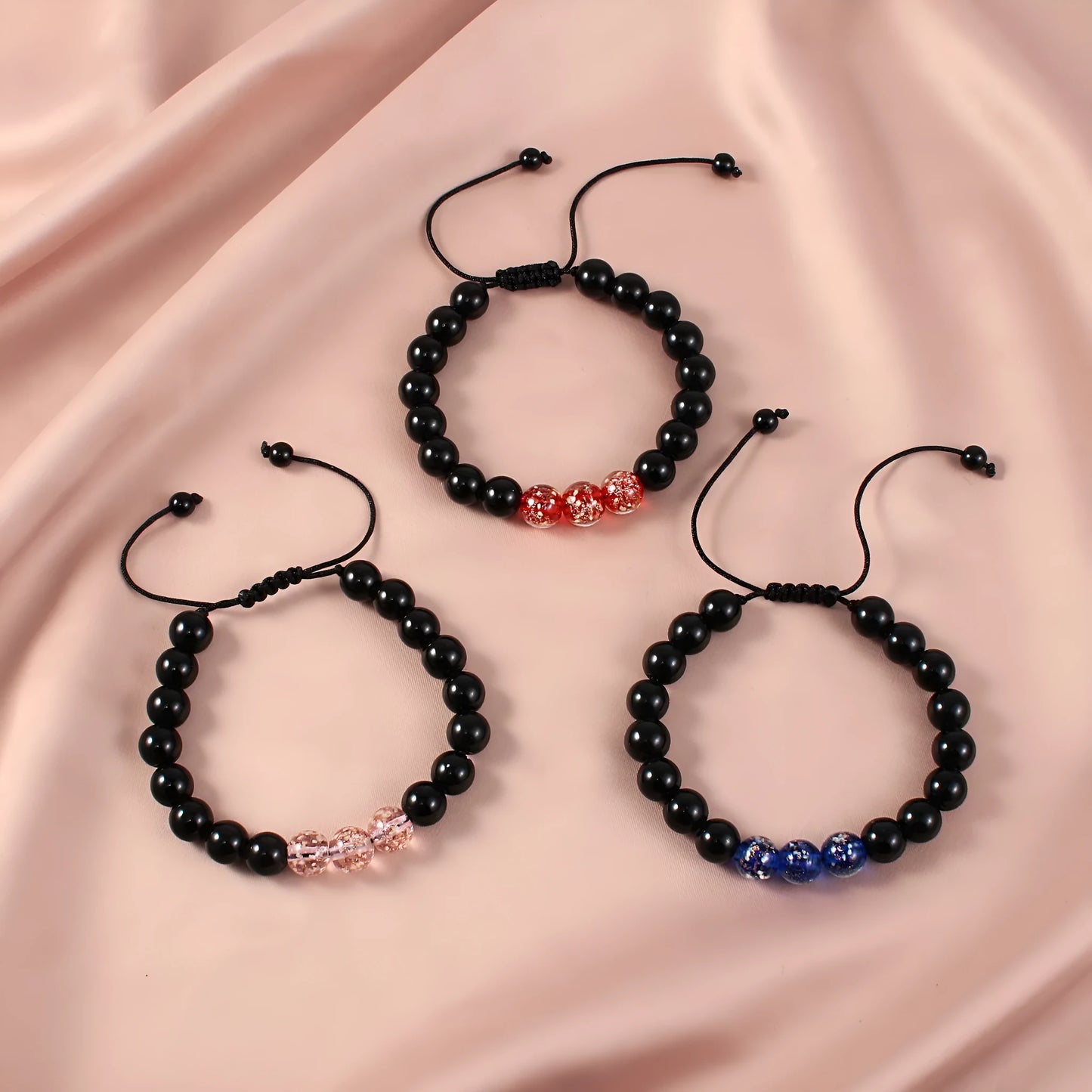 Adjustable luminous beaded bracelet with geometric glass beads on a stretchy elastic band in sapphire blue