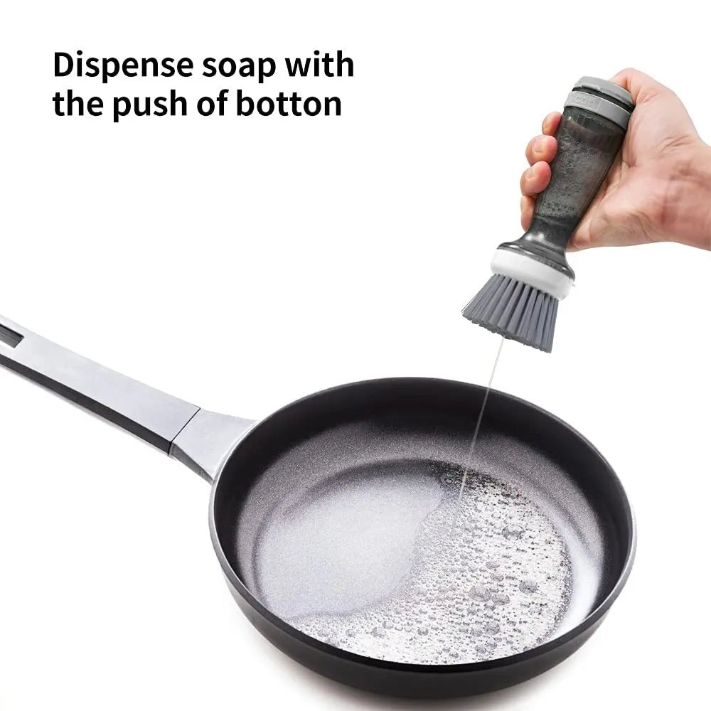 Milk white and mint green pot scrub brush with a soap dispenser handle and replaceable non-scratch bristles.