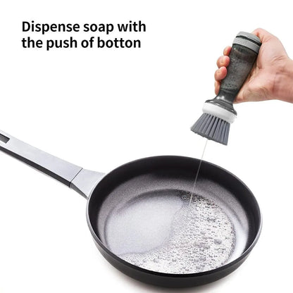 Milk white and mint green pot scrub brush with a soap dispenser handle and replaceable non-scratch bristles.