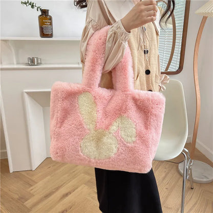 Soft plush tote bag with cartoon rabbit ears in solid colours like beige, pink, and black.