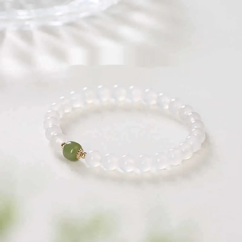 Handmade white agate and crystal bracelet with cinnabar inlay, showing 6mm or 8mm bead options.
