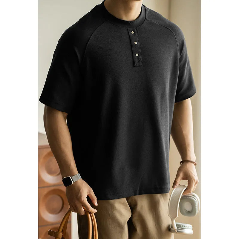 Women's loose grey terry texture casual pullover top with raglan sleeves on a hanger.
