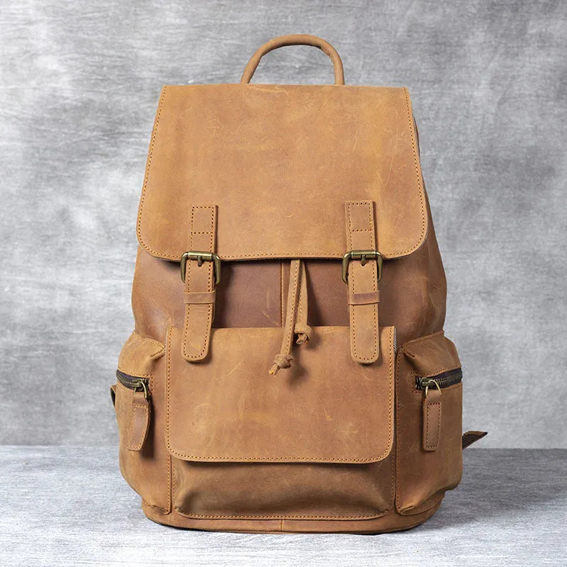 Retro brown genuine cowhide leather backpack with shoulder straps and a top handle.